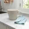 This white ceramic cup is a simple household water cup with a smooth glaze surface after high-temperature firing Specification image